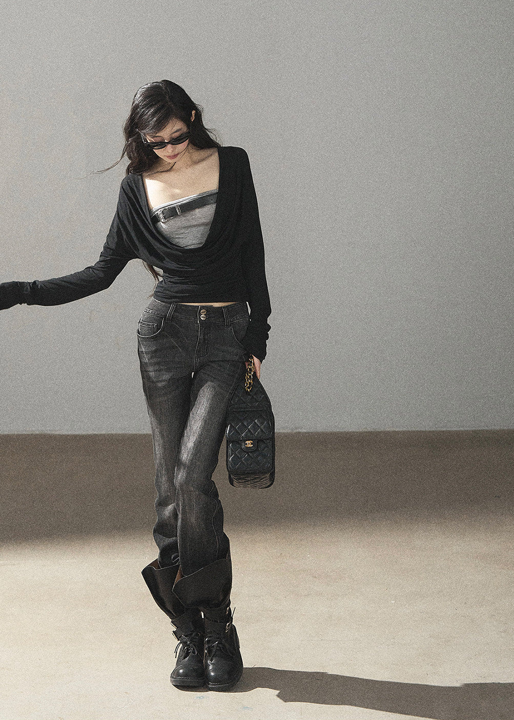 Black waist-fit draped top with gray inner layer