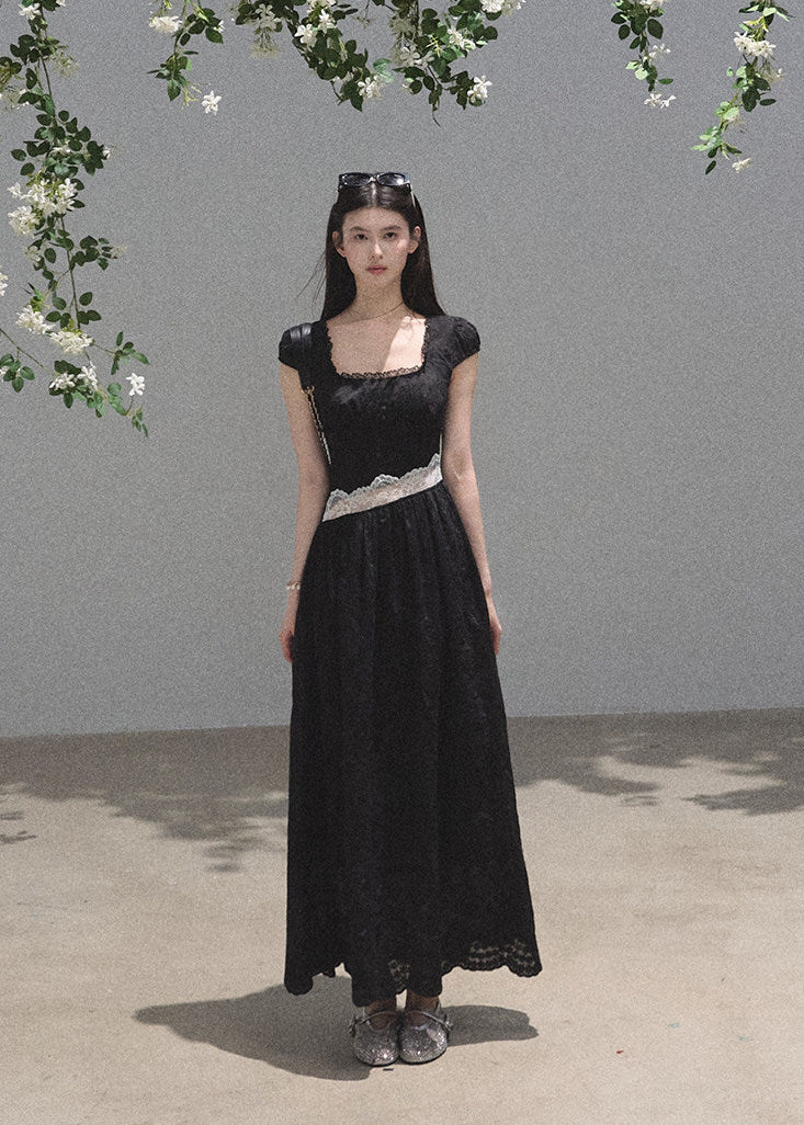 Black full-length dress with sheer lace panel at waist