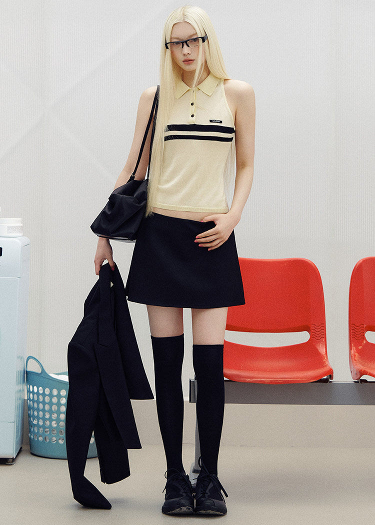 Sleeveless striped knit polo top styled with dark bottoms outdoors