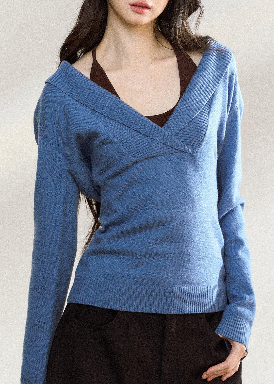 Blue asymmetric knit top with a wide foldover neckline
