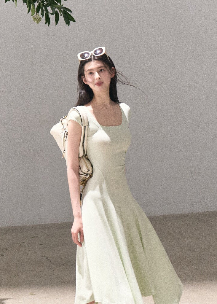 Soft green sleeveless midi dress with elegant drape
