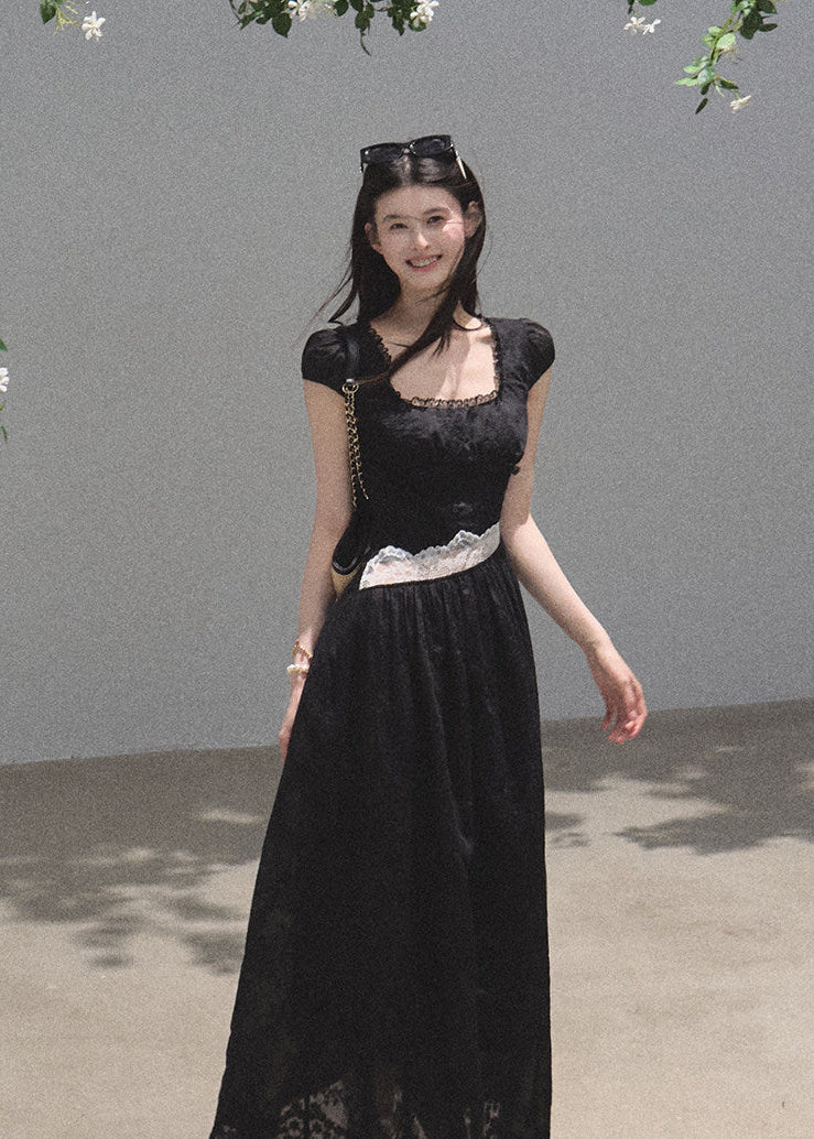 Black full-length dress with sheer lace panel at waist