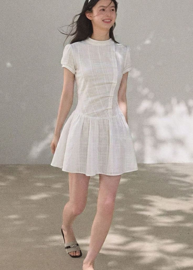 Puff-sleeve mini dress styled with boots