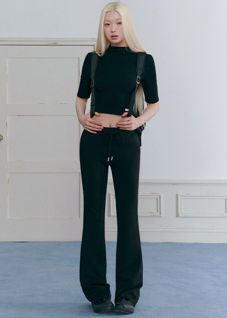 Women’s black cropped mock-neck top and mini skirt matching set