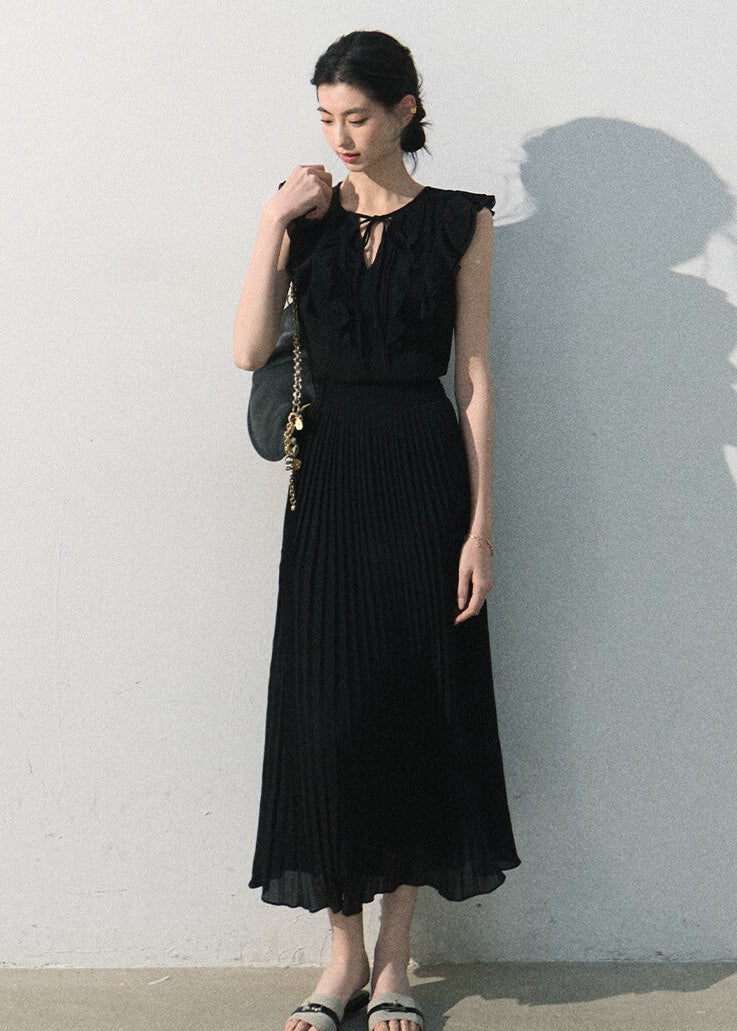 Model wearing a white ruffle dress with a pleated long skirt